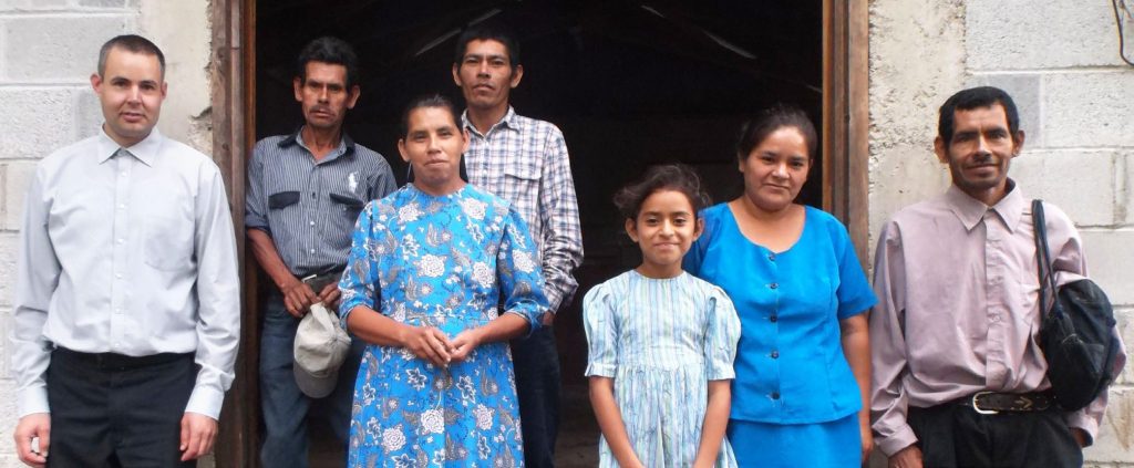 Larry Martin and the small group of believers in Pital stand in front of the chapel.