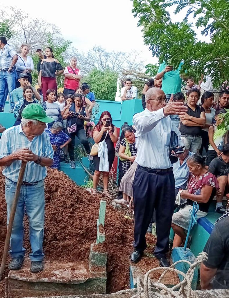 Victor Ovalle preaches to a crowd at the funeral.